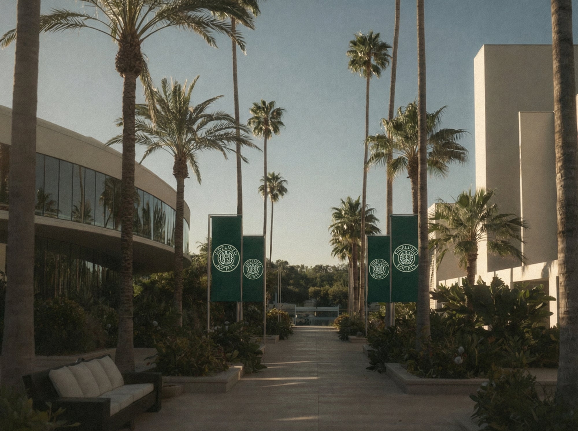 sunlit palm-lined campus walkway with Sidelined Society banners in a clean modern setting